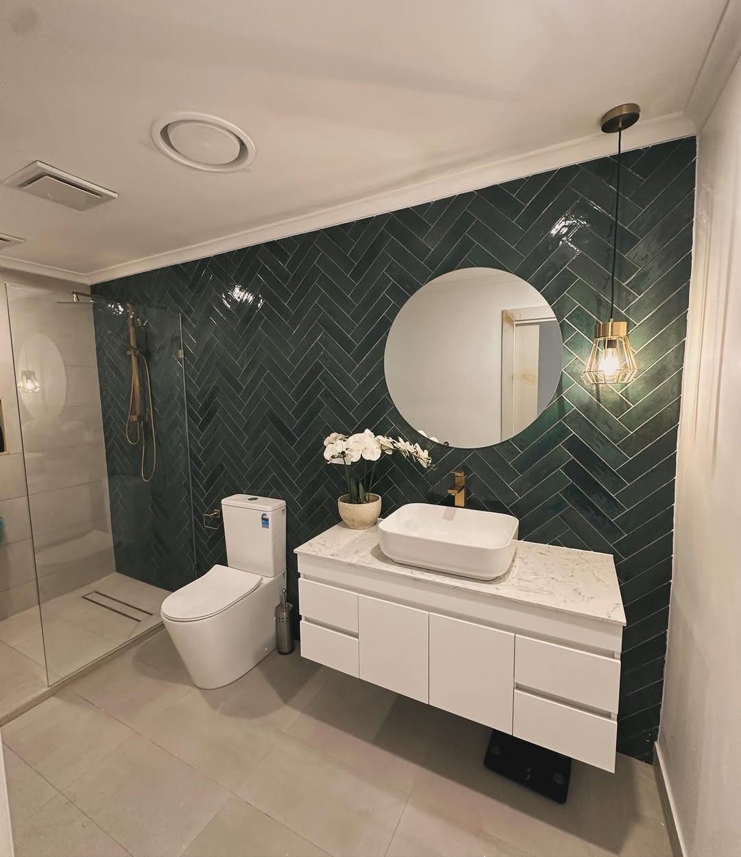 Full bathroom renovation with green herringbone feature